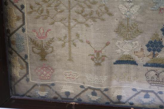 An early 19th century needlework sampler with alphabet, houses, lion, flowers and other motifs, dated 1805, 41 x 31.5cm